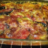 Melanzane al forno con provola, prosciutto cotto, mozzarella e grana 